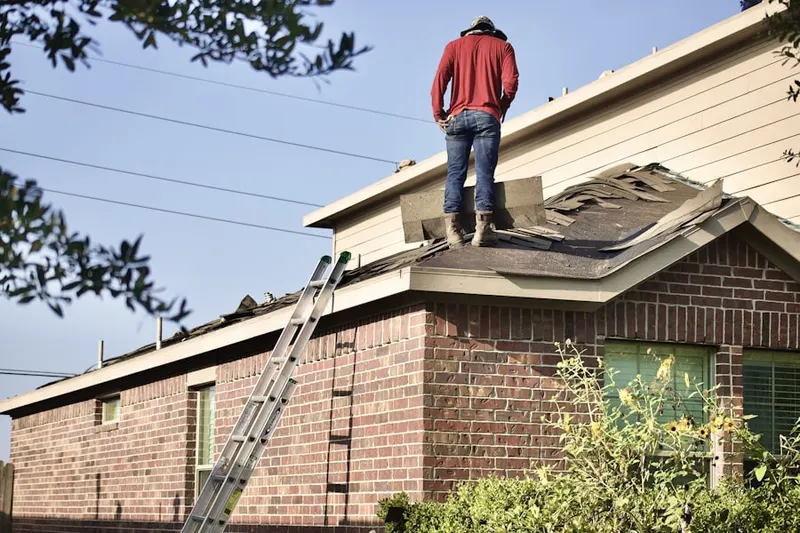 Professional roofer working on a residential roof in Riesel